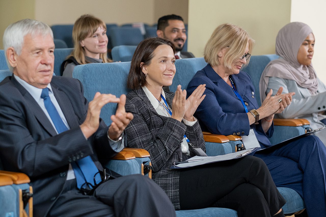 Business Audience Applauding For Speaker