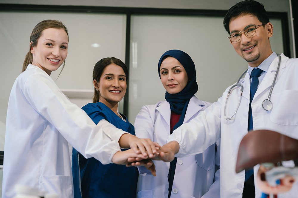 Doctors shaking hands, working together as a team at the hospita